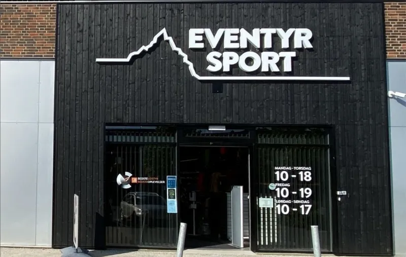 Eventyr Sport storefront showing ZOLES partner location with opening hours displayed on window